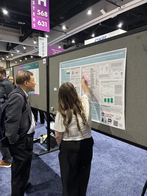SRP trainee presenting a research poster at a conference