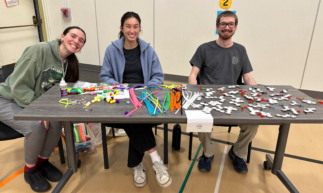 SRP trainees at an outreach table with craft activities